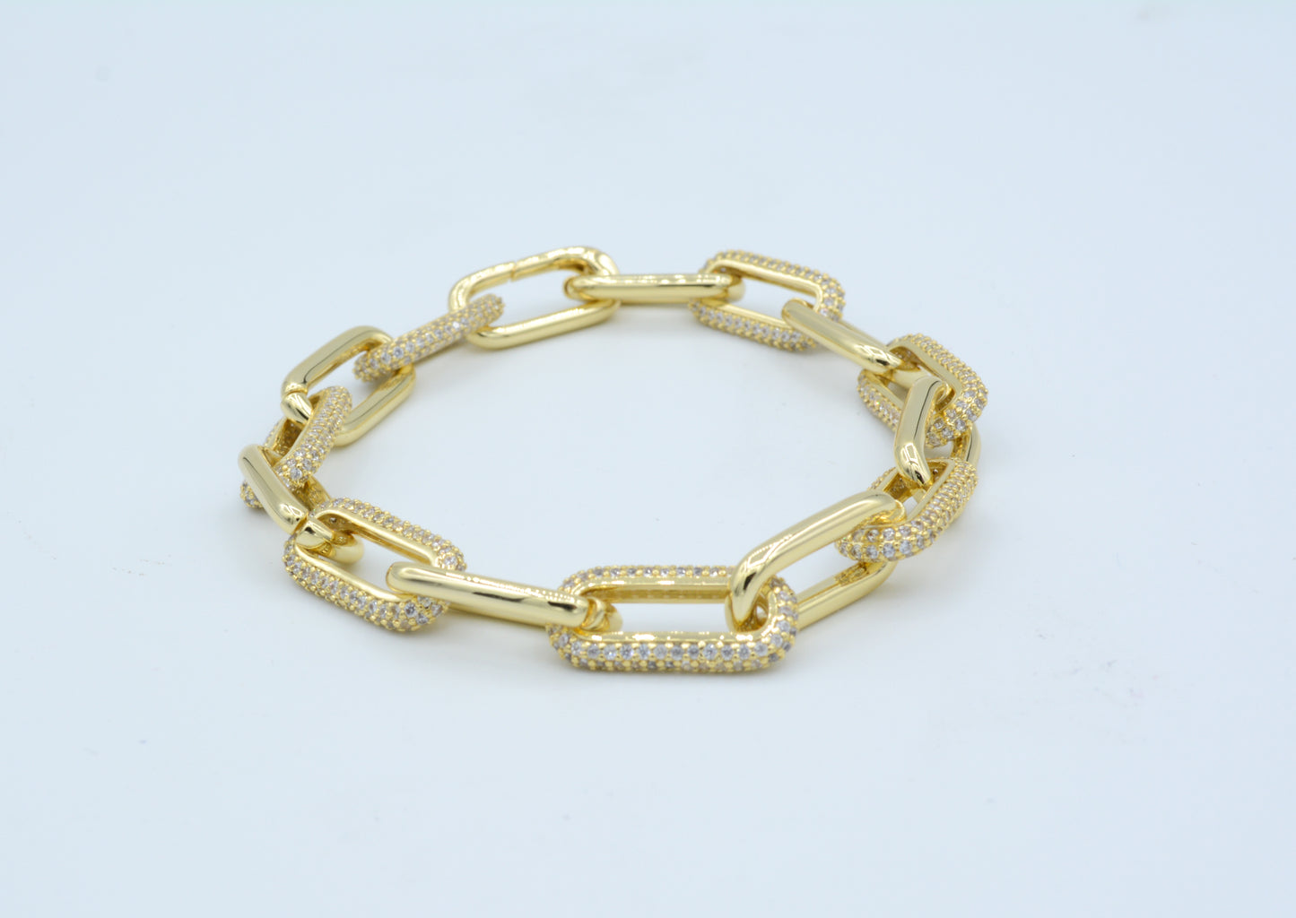 Gold tone paperclip bracelet with pave cz links