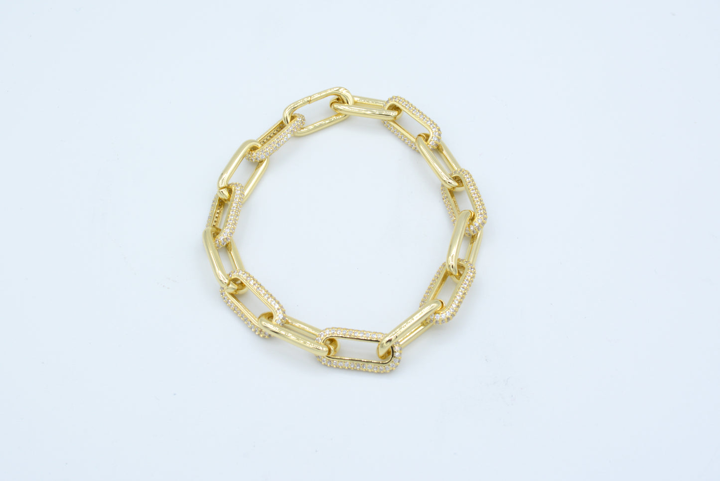 Gold tone paperclip bracelet with pave cz links