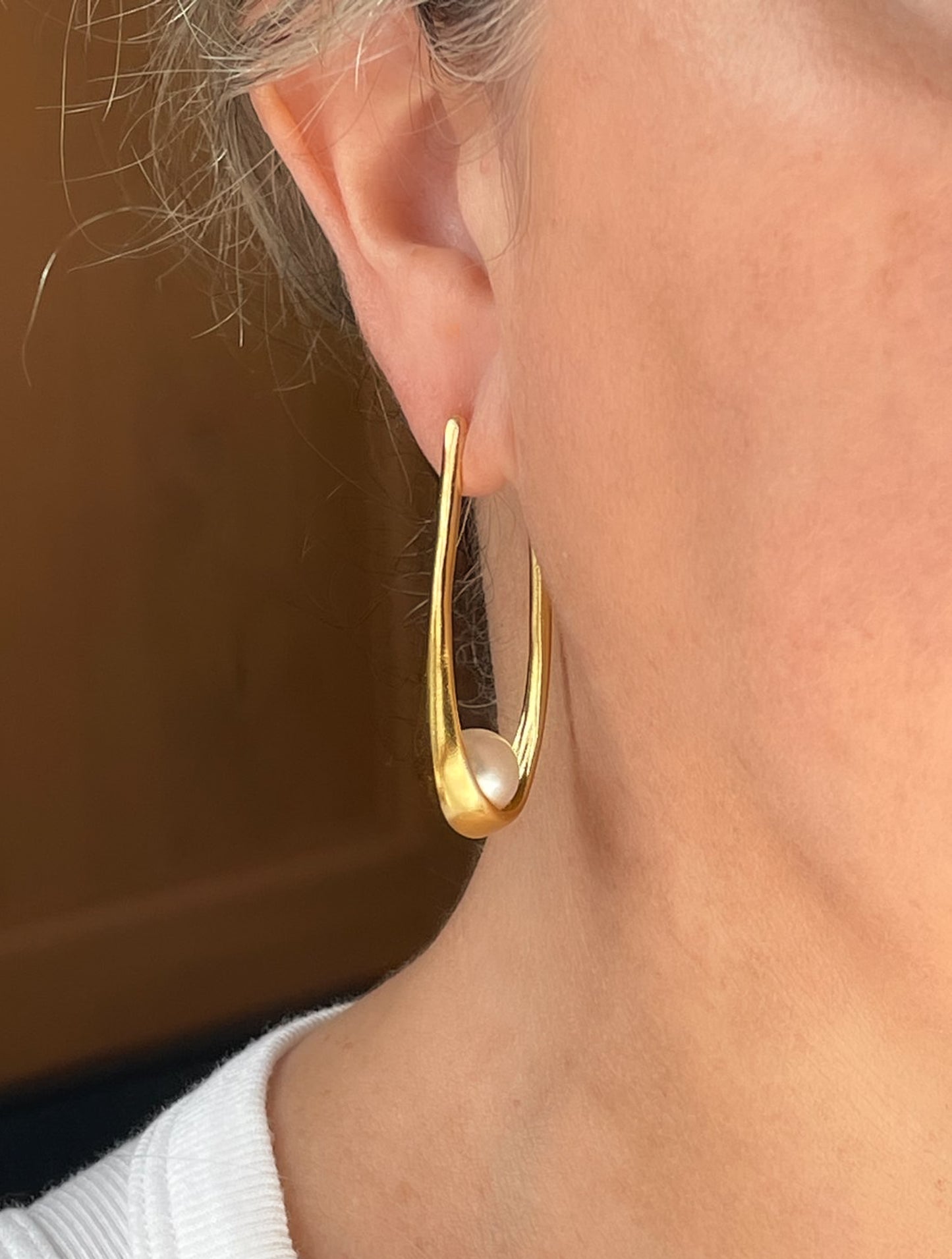 Gold tone elongated hoop with pearl