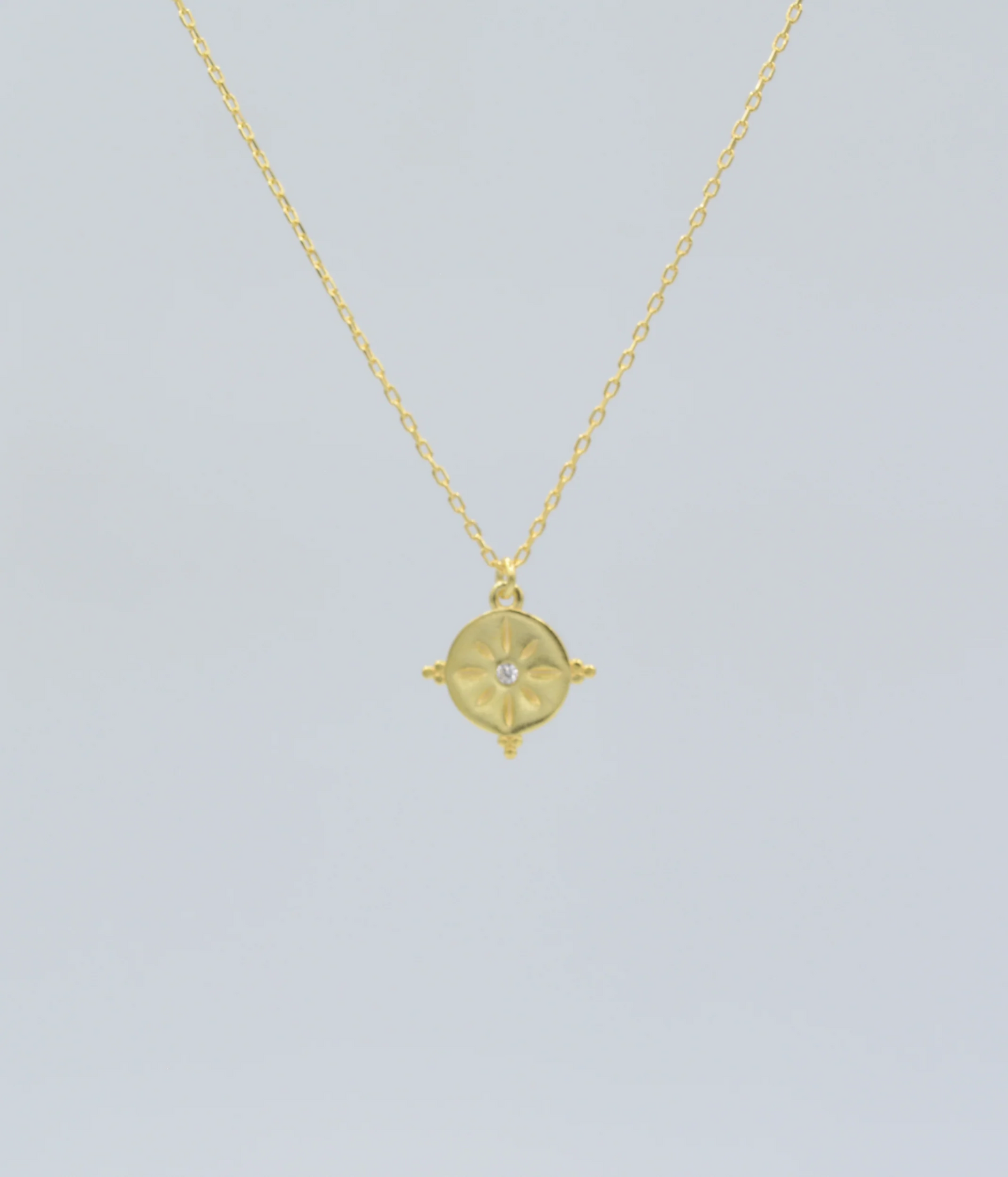 Gold sunburst talisman charm necklace