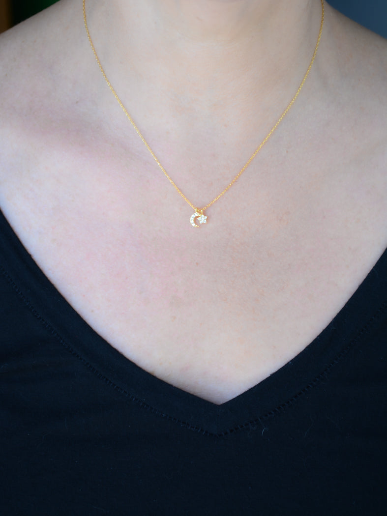 Gold necklace with cubic zirconia moon and star pendant