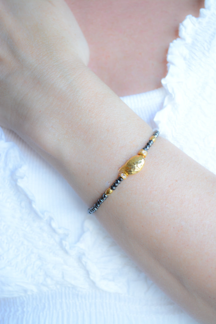 Faceted Hematite, and Gold Plated hammered bead bracelet
