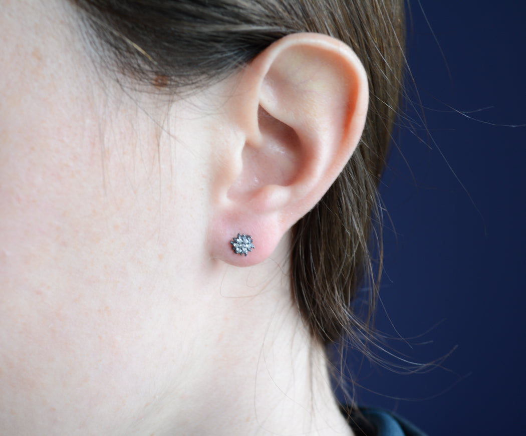 Dark Rhodium sunburst studs with pave cubic zirconia