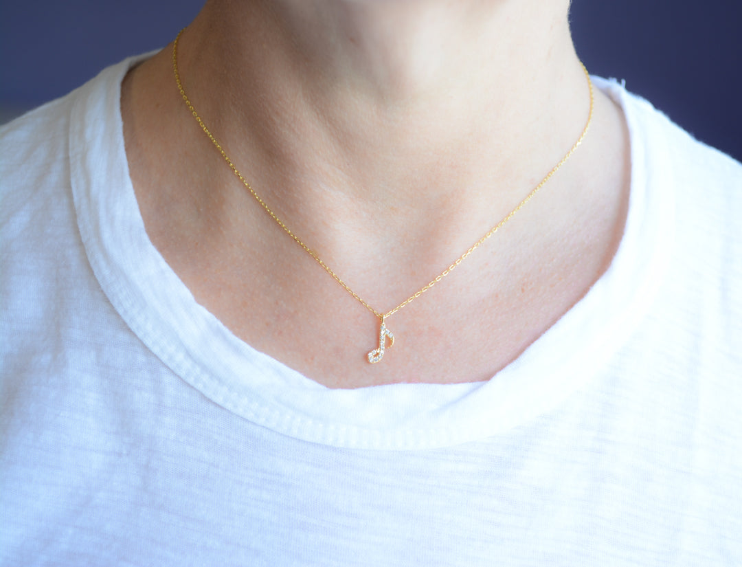 Gold necklace with cubic zirconia music note