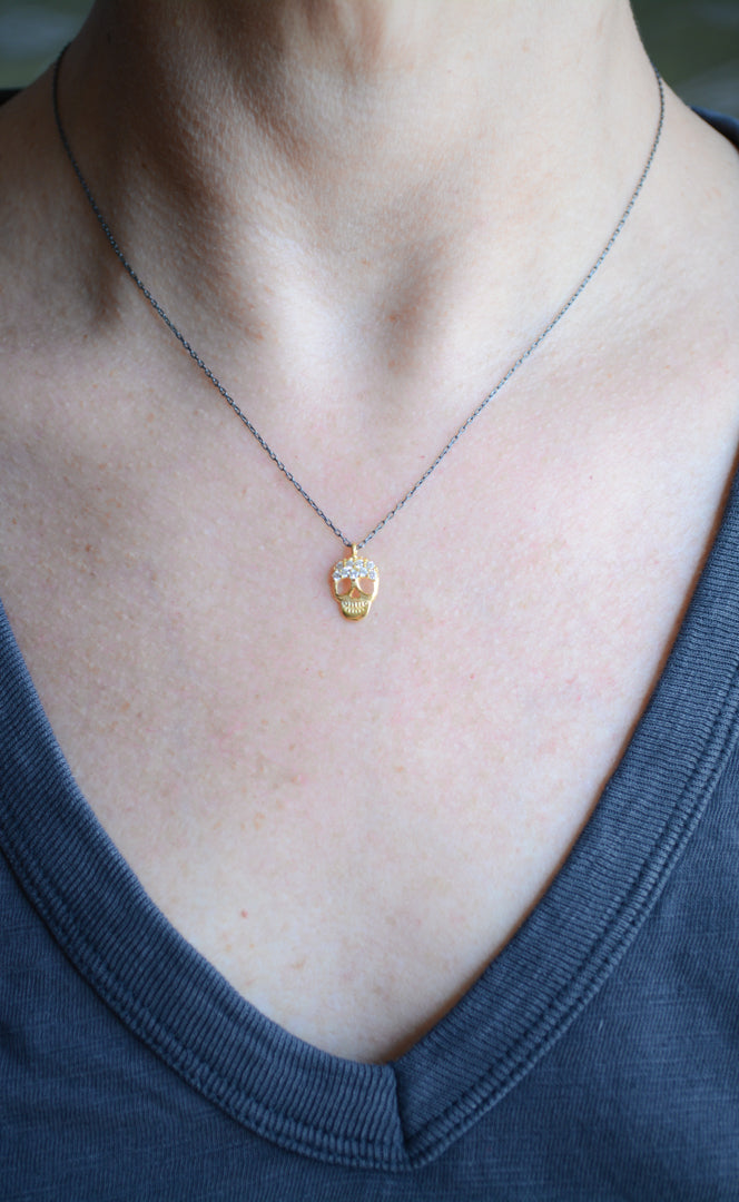 Two-tone skull necklace with cubic zirconia accents