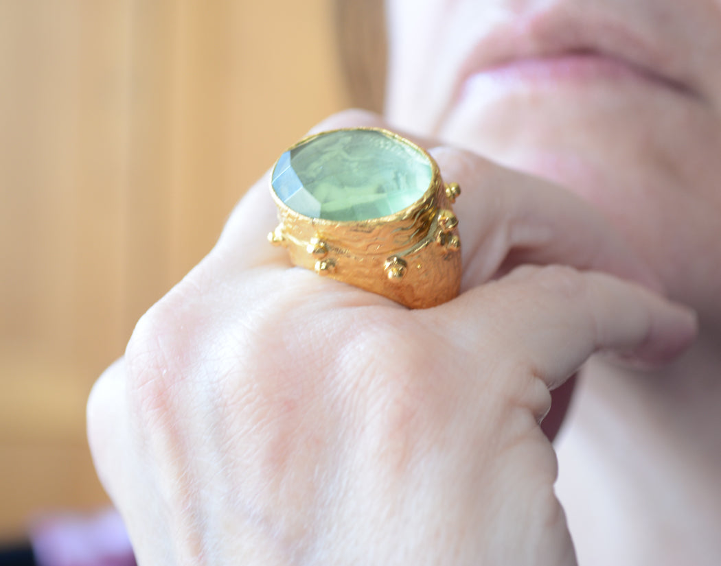 Adjustable gold coin ring with faceted green crystal