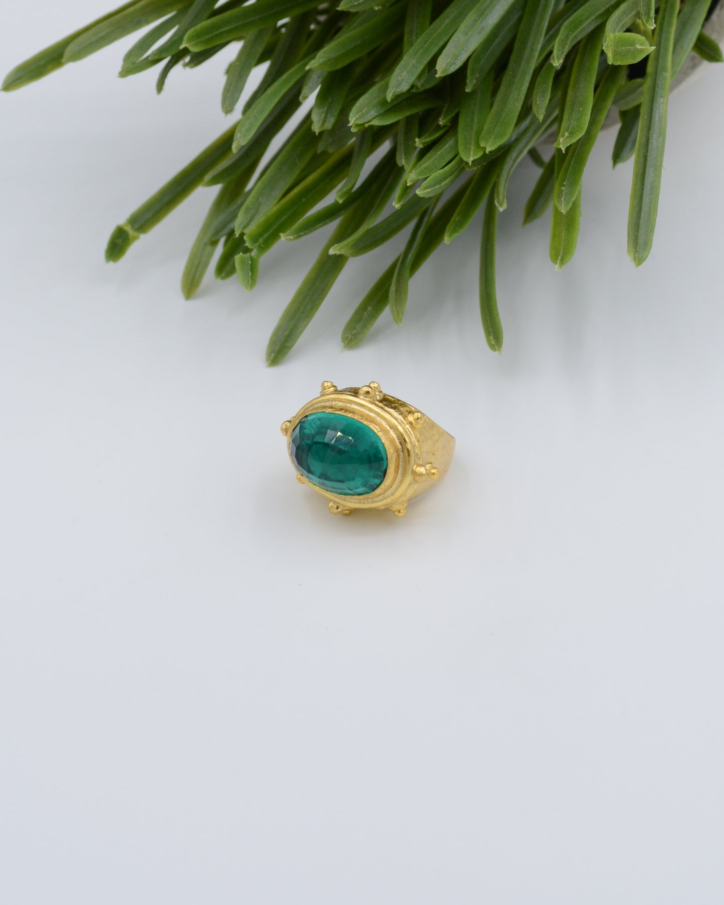 Adjustable gold coin ring with faceted emerald crystal