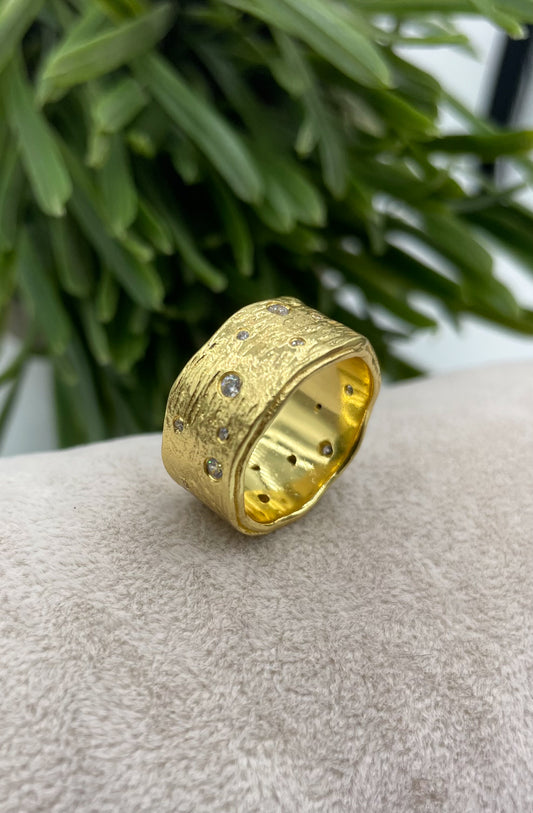 Gold textured band ring with pave set zircons