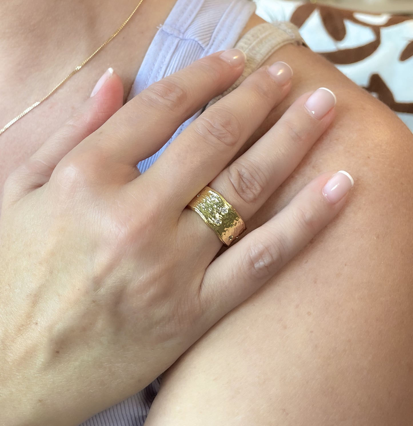 Gold textured band ring with pave set zircons