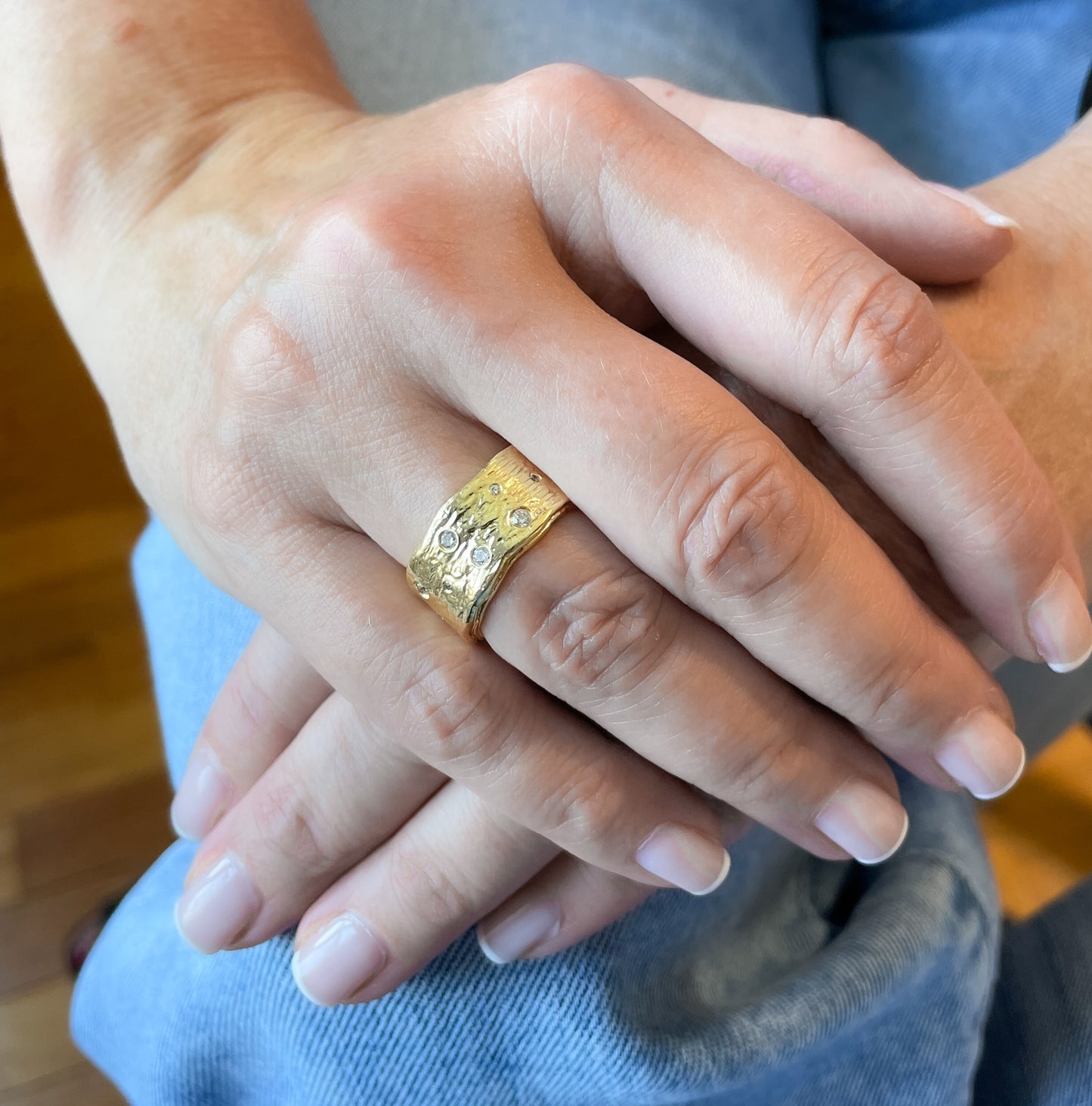 Gold textured band ring with pave set zircons