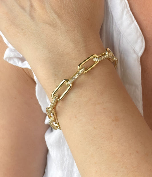 Gold tone paperclip bracelet with pave cz links