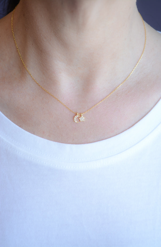 Gold necklace with cubic zirconia moon and star pendant