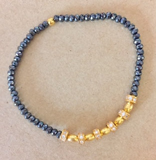 Faceted Hematite and Gold Plated Silver elastic bracelet