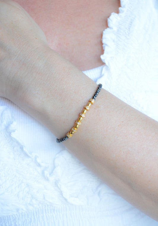 Faceted Hematite and Gold Plated Silver elastic bracelet