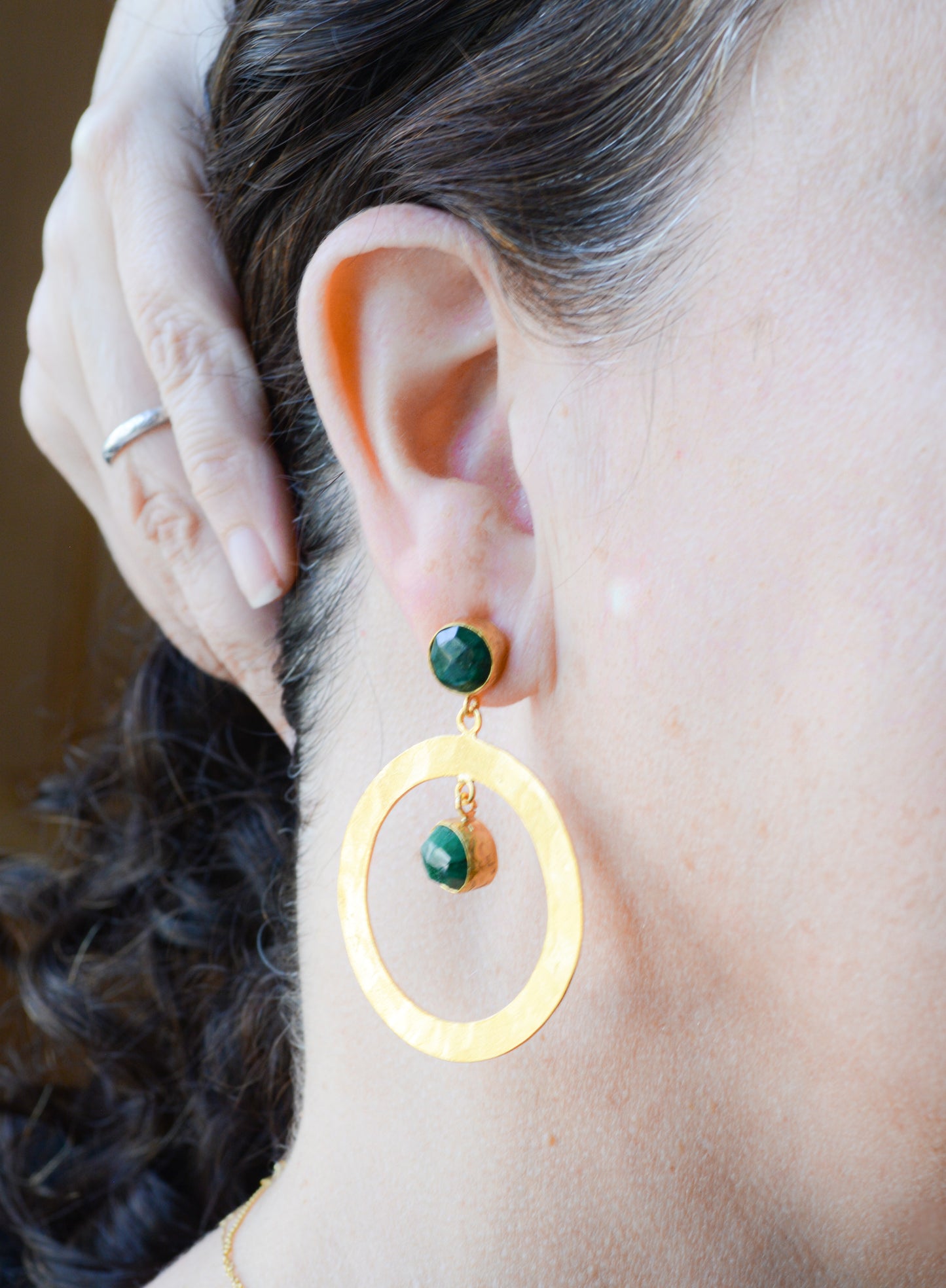 Hammered hoops with post and Emerald stones