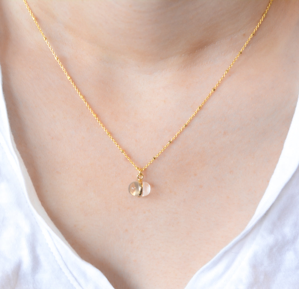 Gold necklace with crystal quartz charm