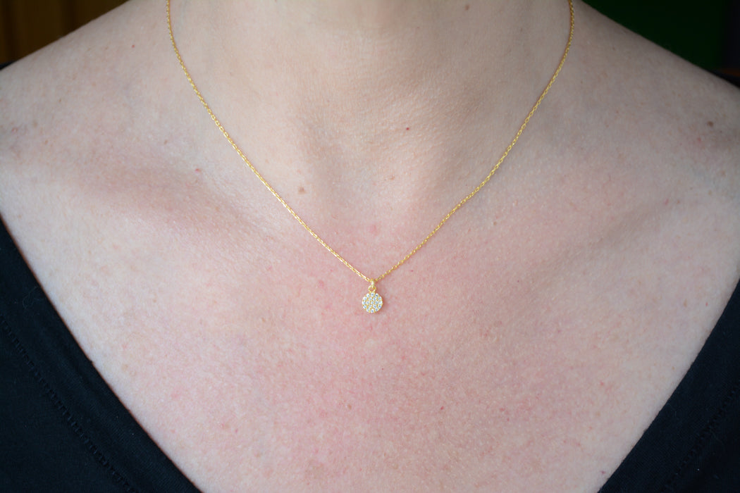 Gold necklace with cubic zirconia disc pendant