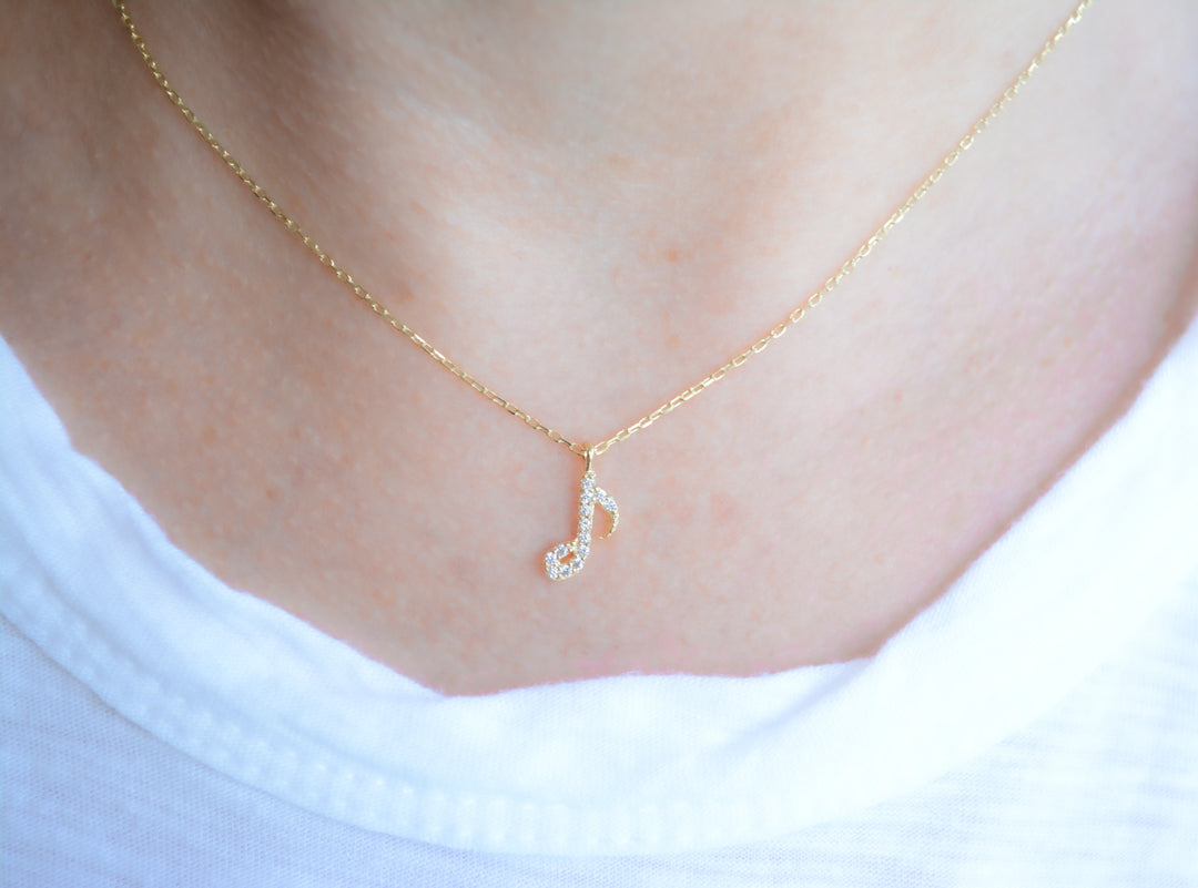 Gold necklace with cubic zirconia music note