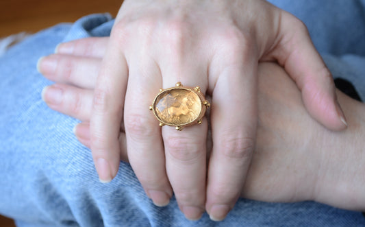 Adjustable gold coin ring with faceted orange crystal