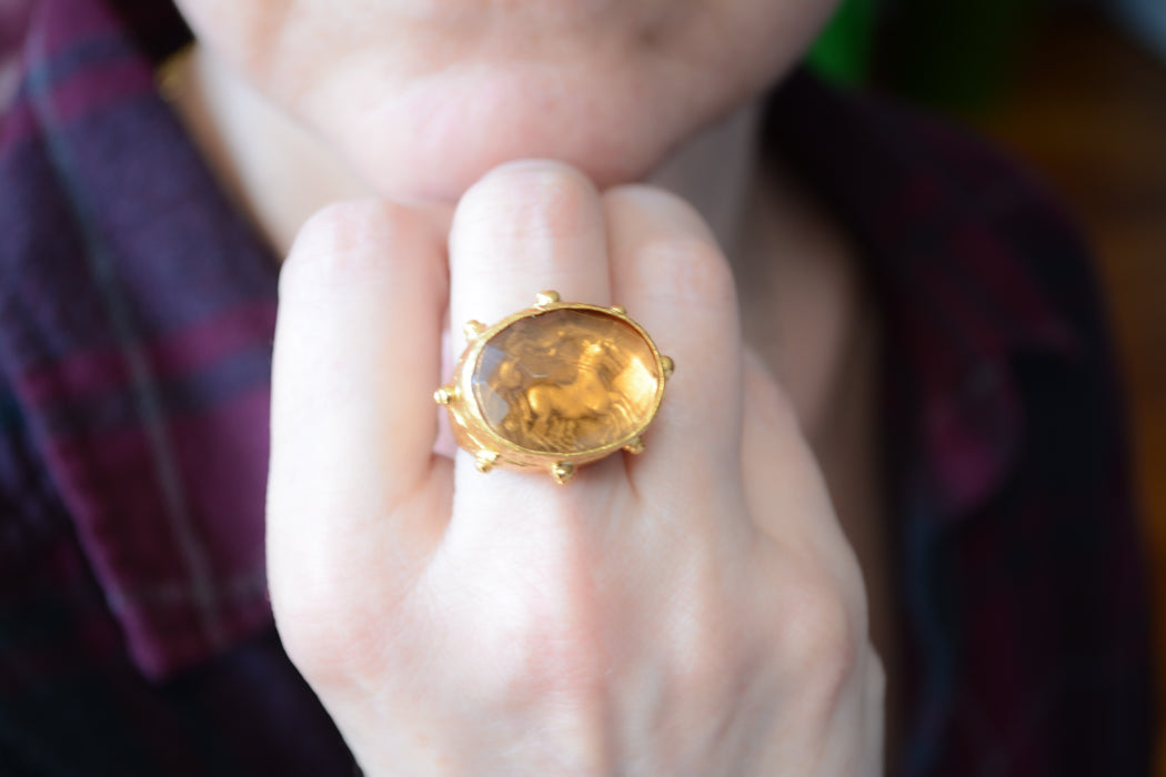 Adjustable gold coin ring with faceted orange crystal