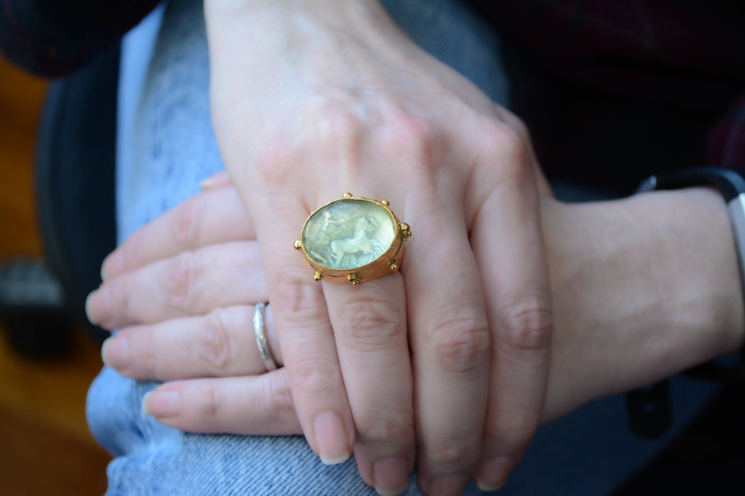 Adjustable gold coin ring with faceted green crystal